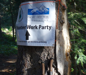 PCT work party sign pinned to a tree